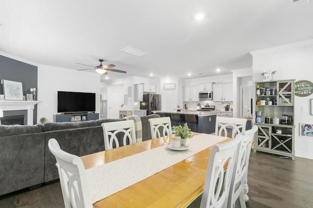 dining room with ceiling fan, dark hardwood / wood-style floors, and ornamental molding