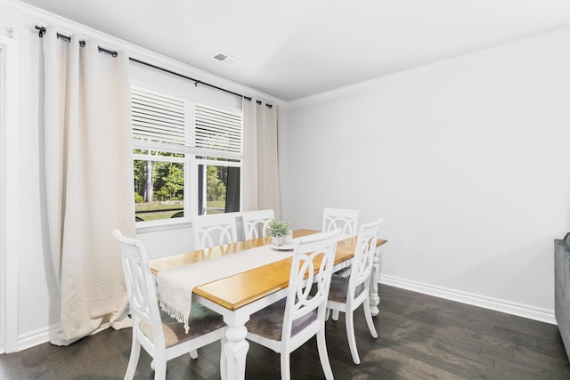 dining space with dark hardwood / wood-style flooring and ornamental molding