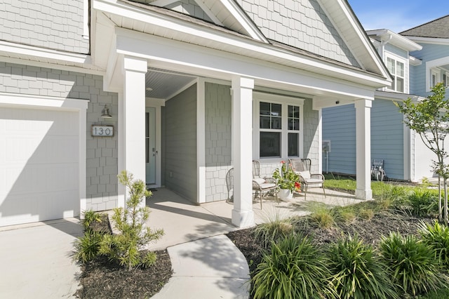 property entrance featuring a garage and covered porch