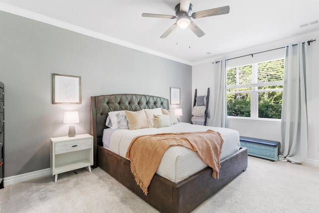 bedroom featuring light carpet, ceiling fan, and crown molding