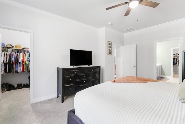 bedroom featuring a spacious closet, ceiling fan, light colored carpet, a closet, and ornamental molding