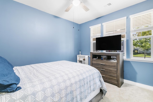 bedroom featuring light carpet and ceiling fan