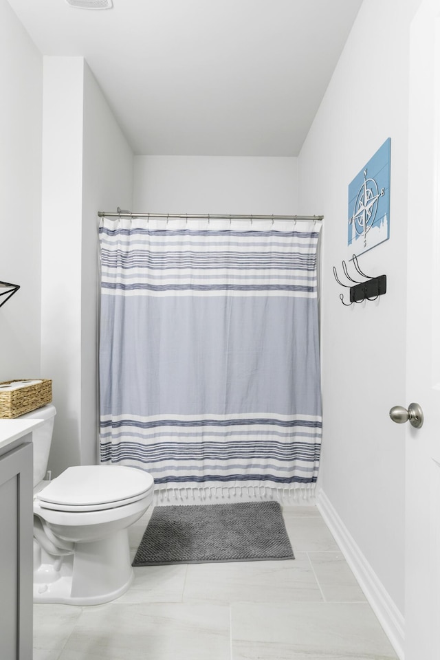 bathroom featuring tile patterned floors, vanity, and toilet