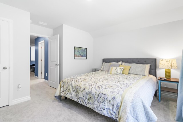 carpeted bedroom with vaulted ceiling