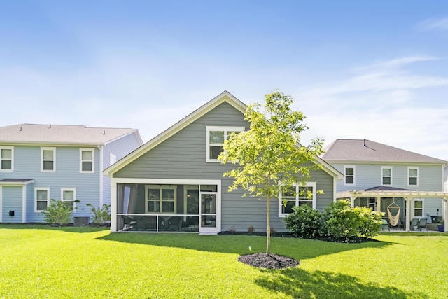 back of property with a sunroom and a yard