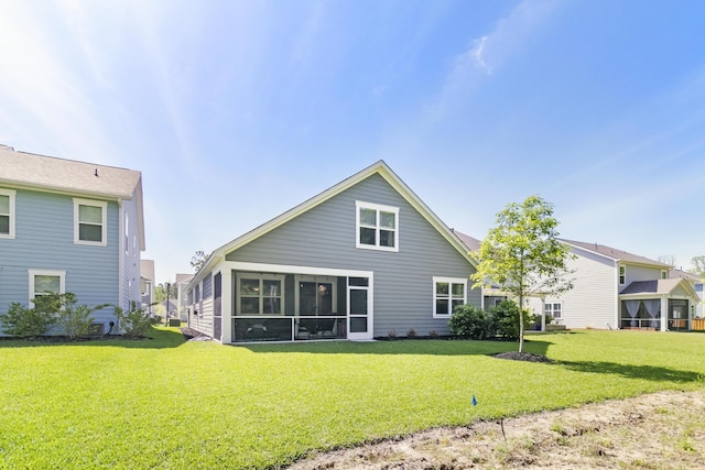 back of property with a lawn and a sunroom