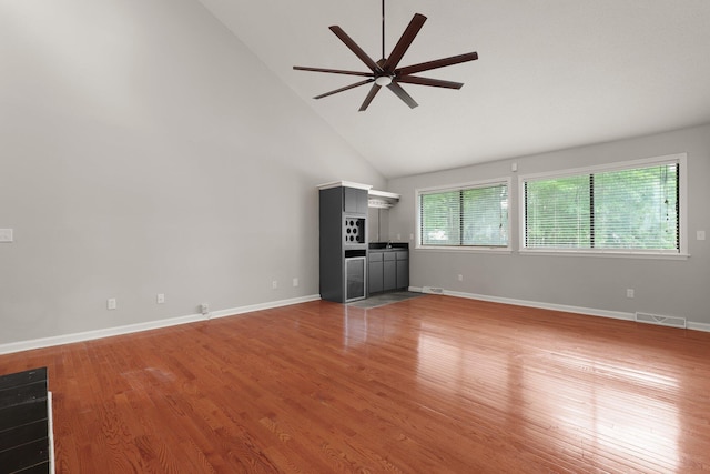 105 Londonderry Rd, Goose Creek, SC 29445 - unfurnished living room featuring ceiling fan, high vaulted ceiling, light wood-style floors, and baseboards