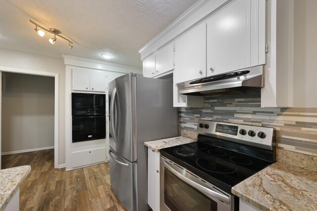 105 Londonderry Rd, Goose Creek, SC 29445 - kitchen featuring stainless steel appliances, under cabinet range hood, wood finished floors, white cabinetry, and tasteful backsplash