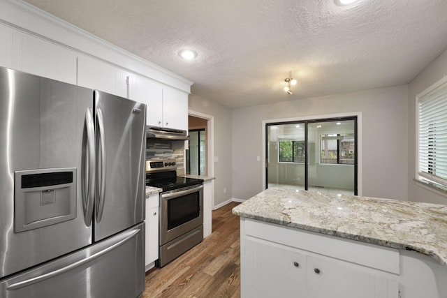 105 Londonderry Rd, Goose Creek, SC 29445 - kitchen featuring appliances with stainless steel finishes, under cabinet range hood, white cabinets, wood finished floors, and a textured ceiling