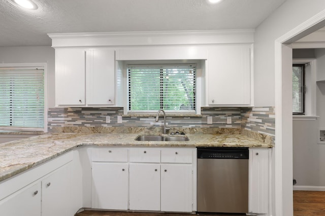 105 Londonderry Rd, Goose Creek, SC 29445 - kitchen with stainless steel dishwasher, a sink, white cabinetry, decorative backsplash, and a textured ceiling