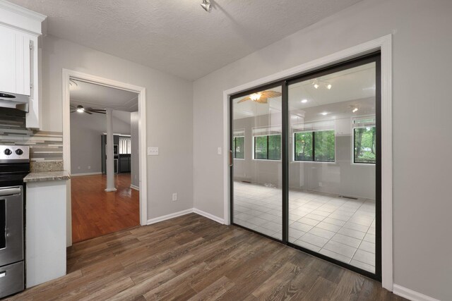 105 Londonderry Rd, Goose Creek, SC 29445 - kitchen featuring dark wood-style floors, stainless steel range with electric stovetop, white cabinets, a ceiling fan, and a textured ceiling