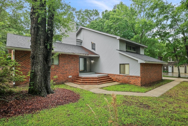 105 Londonderry Rd, Goose Creek, SC 29445 - back of house with brick siding, a lawn, and roof with shingles