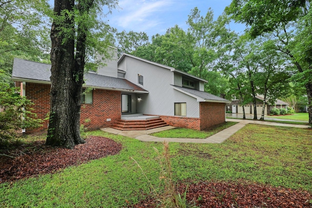 105 Londonderry Rd, Goose Creek, SC 29445 - back of house featuring brick siding, a yard, and a shingled roof