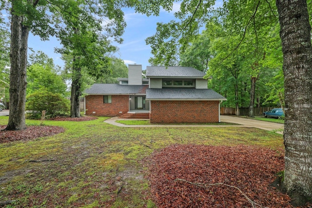 105 Londonderry Rd, Goose Creek, SC 29445 - view of front of property featuring a chimney, brick siding, and driveway
