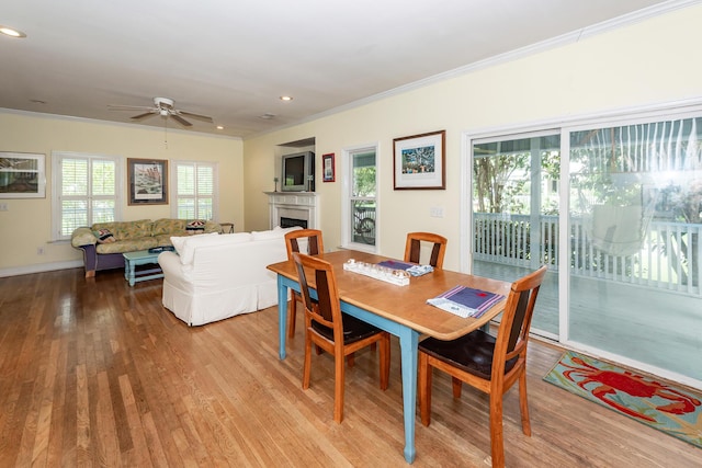 2613 Rivertowne Pkwy, Mount Pleasant, SC 29466 - dining space with crown molding, ceiling fan, light wood-type flooring, a fireplace, and recessed lighting