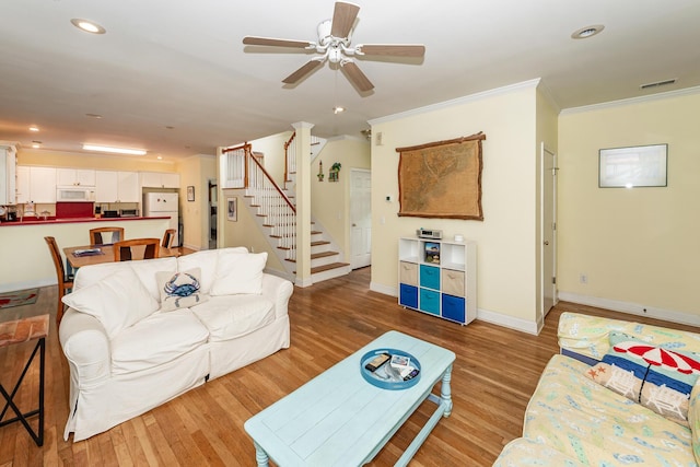 2613 Rivertowne Pkwy, Mount Pleasant, SC 29466 - living room with stairway, light wood-type flooring, baseboards, ornamental molding, and a ceiling fan