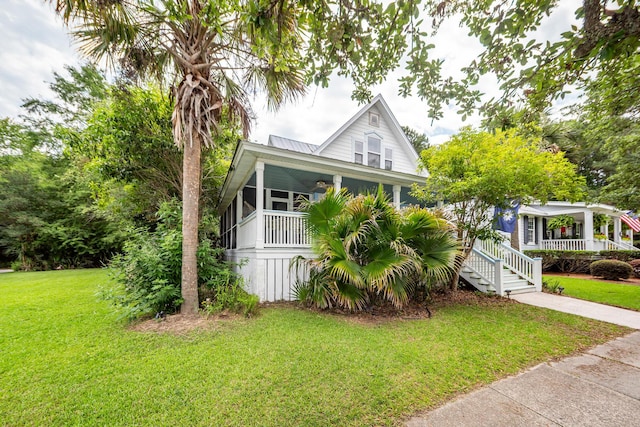 2613 Rivertowne Pkwy, Mount Pleasant, SC 29466 - view of front of house featuring a porch, a front lawn, and metal roof