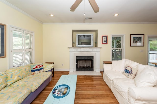 2613 Rivertowne Pkwy, Mount Pleasant, SC 29466 - living room featuring ornamental molding, wood finished floors, a fireplace with flush hearth, ceiling fan, and baseboards
