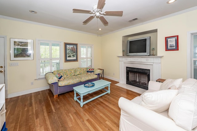 2613 Rivertowne Pkwy, Mount Pleasant, SC 29466 - living area featuring ornamental molding, a tiled fireplace, a ceiling fan, light wood-style floors, and baseboards