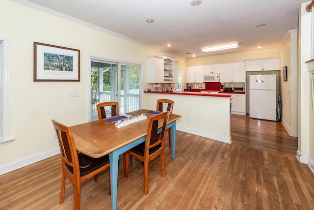 2613 Rivertowne Pkwy, Mount Pleasant, SC 29466 - dining area featuring crown molding, wood finished floors, baseboards, and recessed lighting