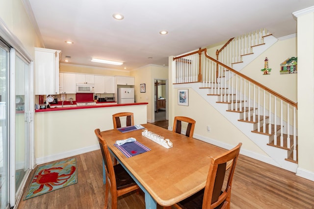 2613 Rivertowne Pkwy, Mount Pleasant, SC 29466 - dining room with wood finished floors, stairway, recessed lighting, crown molding, and baseboards