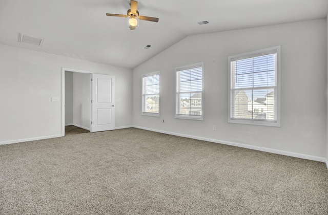 unfurnished bedroom with ceiling fan, vaulted ceiling, and carpet flooring