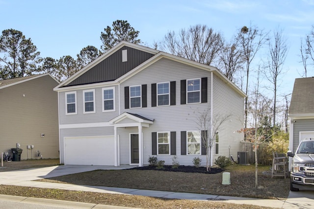 view of front facade featuring a garage and central air condition unit