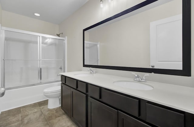 full bathroom with toilet, vanity, and shower / bath combination with glass door