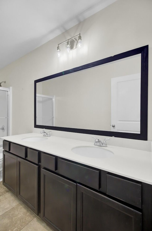 bathroom featuring toilet, tile patterned flooring, walk in shower, and vanity