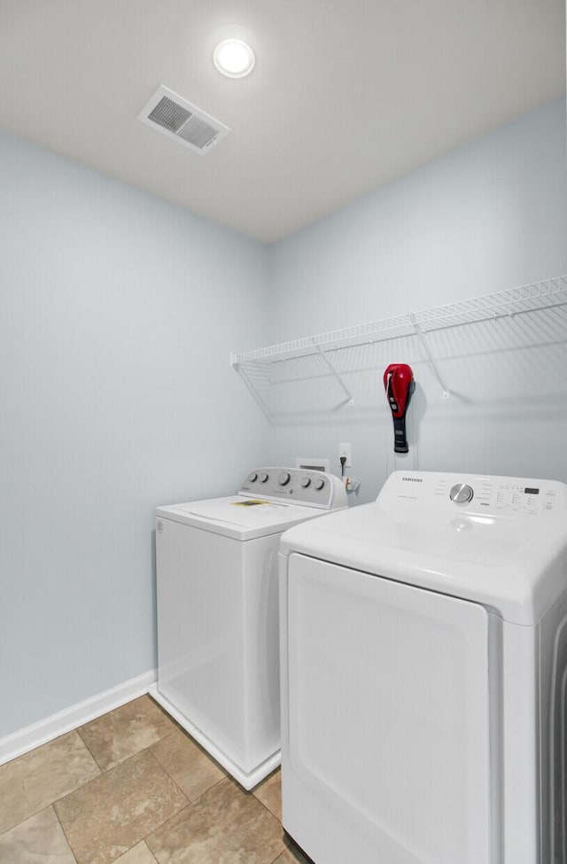 laundry room featuring washing machine and clothes dryer