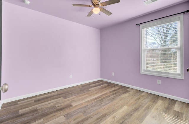 spare room with light hardwood / wood-style floors and ceiling fan