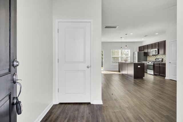 foyer entrance featuring dark wood-type flooring