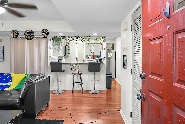 foyer entrance with recessed lighting, wood finished floors, baseboards, and ceiling fan