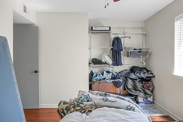 walk in closet with visible vents and wood finished floors