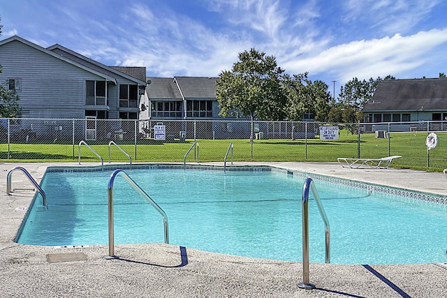 pool with a lawn and fence