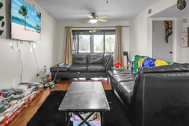 living area featuring wood finished floors, visible vents, and ceiling fan