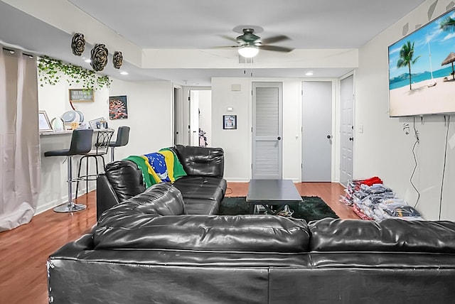 living room featuring ceiling fan and wood finished floors