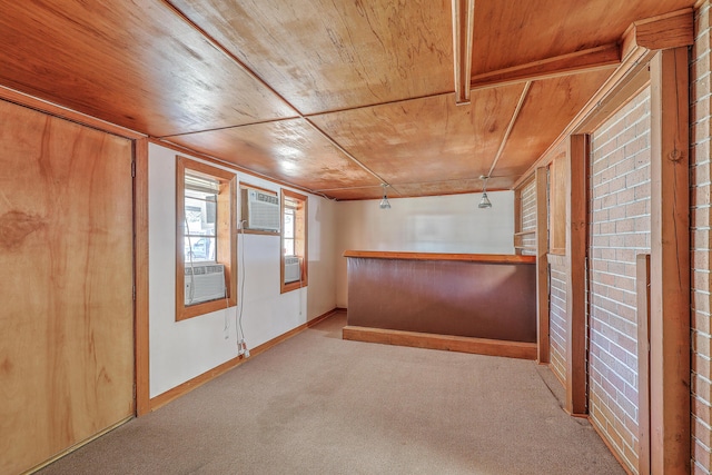 interior space with carpet, cooling unit, wood ceiling, and baseboards