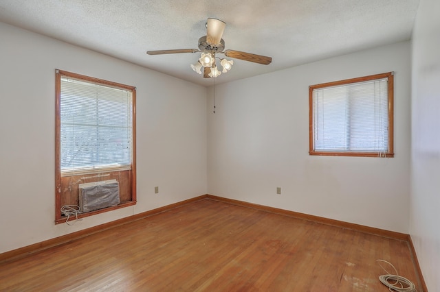 empty room featuring baseboards, plenty of natural light, and wood finished floors