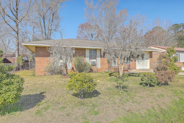 single story home featuring a front lawn, a garage, fence, and brick siding