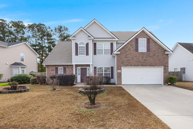 view of front of home featuring a garage and a front lawn