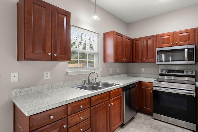 kitchen with sink, pendant lighting, and appliances with stainless steel finishes