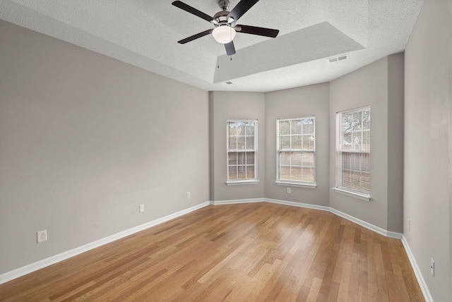 unfurnished room with ceiling fan, light hardwood / wood-style flooring, and a textured ceiling