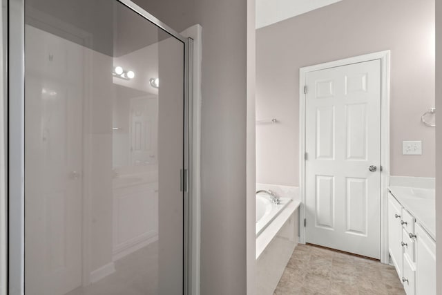 bathroom with vanity and independent shower and bath