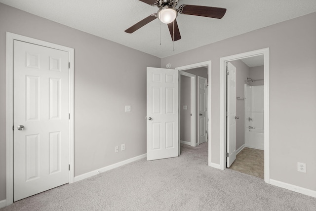 unfurnished bedroom featuring connected bathroom, ceiling fan, light colored carpet, and a textured ceiling