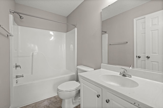 full bathroom featuring tile patterned floors, vanity, a textured ceiling, bathing tub / shower combination, and toilet