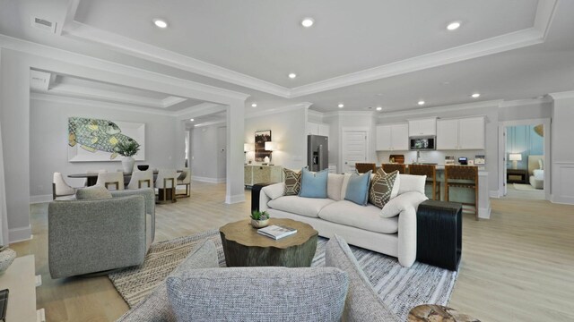 212 Bilge Rd, Ridgeville, SC 29472 - living area featuring a tray ceiling, light wood-style flooring, recessed lighting, baseboards, and crown molding