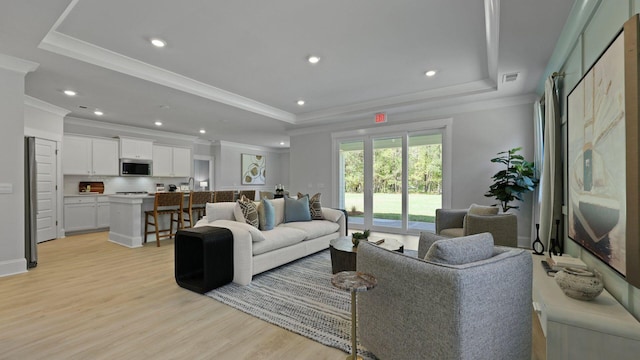 212 Bilge Rd, Ridgeville, SC 29472 - living room with a raised ceiling, ornamental molding, light wood finished floors, and recessed lighting