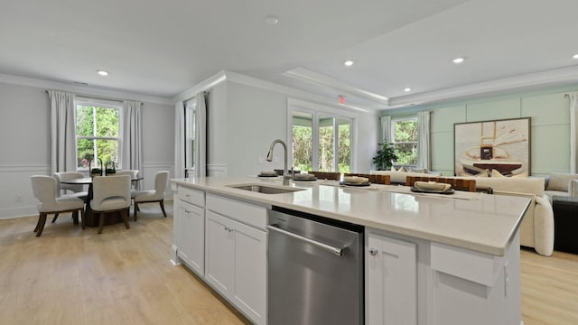212 Bilge Rd, Ridgeville, SC 29472 - kitchen featuring dishwasher, a sink, crown molding, open floor plan, and light wood-style floors