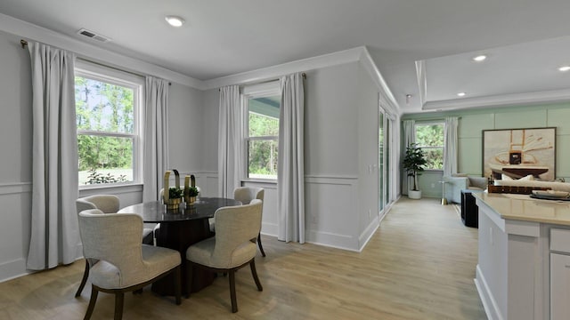 212 Bilge Rd, Ridgeville, SC 29472 - dining space with healthy amount of natural light, light wood-style flooring, crown molding, recessed lighting, and a decorative wall